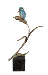 Bronze sculpture of a bird perched on a branch with a white background