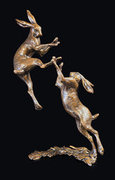 Bronze sculpture of two hares boxing