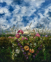 summer meadow of pink, orange and white flowers against a blue sky.