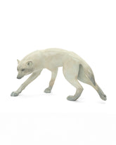 bronze sculpture of white fox standing