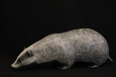 Bronze sculpture of a badger on a black background