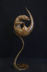 Bronze otter curled up and fixed to a matching curved stand