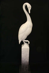 White swan sculpture on a black background
