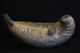 Bronze sculpture of a seal on a black background