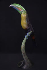 Bronze sculpture of vibrant toucan bird on a stand