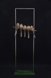 Sculpture of 5 birds in a frame.