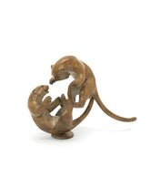 bronze sculpture of two leopards playing