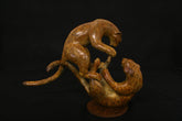 bronze sculpture of two leopards play fighting