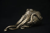 Bronze octopus sculpture on a black background