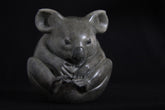 Sculpture of grey Koala curled up in a ball