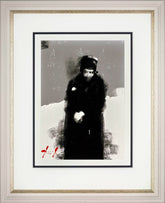 Framed artwork of a person in a dark coat and hat standing in snow.