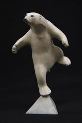 White polar bear figurine on a black background