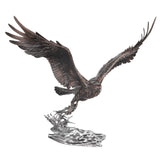 Bronze sculpture of an eagle in flight over water on a white background