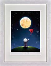 Framed artwork of a character on a planet looking at the moon with a heart-shaped balloon.