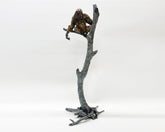 Bronze sculpture of orangutan perched on a tree branch