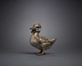 Ceramic duck figurine on a gray background