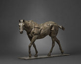 Bronze sculpture of a horse on a gray background