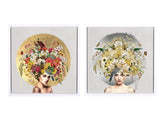 Two framed square art prints side by side, each showing a stylized portrait of a woman with a large floral headpiece. The left print has a gold circular background with multicolored flowers, and the right print has a gray circular background with white and yellow flowers.