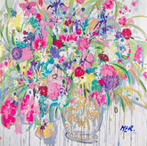 Colorful floral arrangement with a decorative vase on a light background