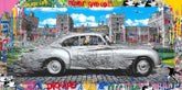 Vintage car on a colorful urban street with graffiti and text