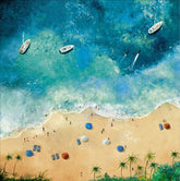 Aerial view of a beach with people, umbrellas, and boats in the ocean.
