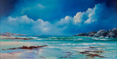 Coastal scene with rocky shore, clear blue sky, and turquoise water.