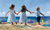 Children holding hands on a beach with colorful flags and ocean view
