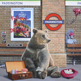 Illustration of a bear sitting on a bench with a suitcase, surrounded by Paddington-themed elements.