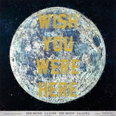 art with text 'Wish You Were Here' featuring a large cratered moon or planet in a starry black space background, with the title text in gold lettering across the centre and a white band at the bottom with text