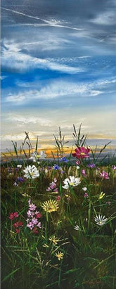 Framed artwork of a field with flowers and a blue sky.