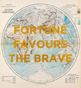 Vintage-style world map poster with large yellow text reading 'FORTUNE FAVOURS THE BRAVE' across the center. The map shows the Eastern Hemisphere with beige landmasses and pale blue oceans, plus small printed legend details around the edges.