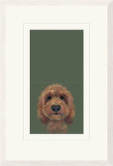 Framed art print featuring a painted portrait of a brown curly-haired dog on a muted olive green background, shown with a wide white mat and light wood frame.