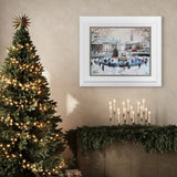 Decorative room with a Christmas tree, framed artwork, and candles on a mantelpiece.