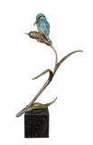 Bronze sculpture of a bird perched on a branch with a white background