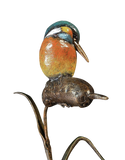Metallic sculpture of a kingfisher on a branch against a white background