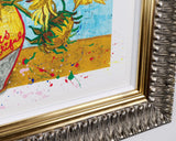 ornate frame of sunflower flowers in a yellow vase set against a light blue background with paint splaters.
