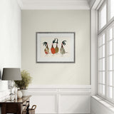 Framed artwork of three stylized birds on a wall in a room with a lamp and plant.