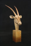 Bronze bust of an Oryx head on a dark background