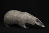 Bronze sculpture of a badger on a black background