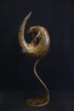 Bronze otter curled up and fixed to a matching curved stand