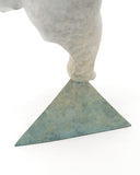 white polar bear balancing on one foot on a triangle base featuring signature