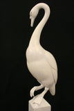 White swan sculpture on a black background
