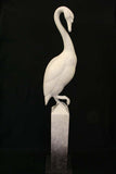 White swan sculpture on a black background