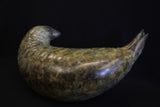 Bronze sculpture of a seal on a black background