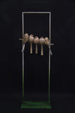 Sculpture of 5 birds in a frame.