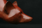 Close-up of a red fox bronze sculpture on a black background