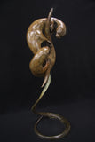 Bronze sculpture of a two otters on a black background