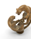 bronze sculpture of two leopards playing
