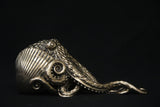 Bronze octopus sculpture on a black background