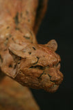 Bronze sculpture of a dynamic cheetah on a dark background